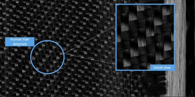 Human hair detected on a carbon fiber sample using high-resolution machine vision